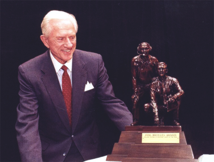 Frank Broyles with the Broyles Award trophy